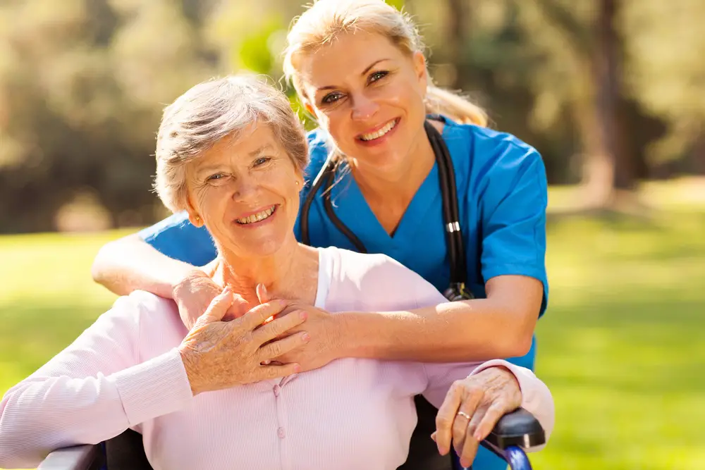 Caregiver Nurse Taking Care Of The Resident