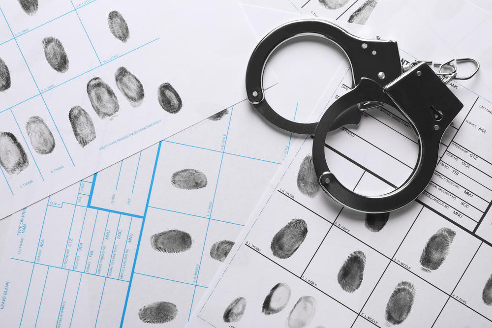 Handcuffs And Fingerprint Record Sheets, Top View. Criminal Investigation